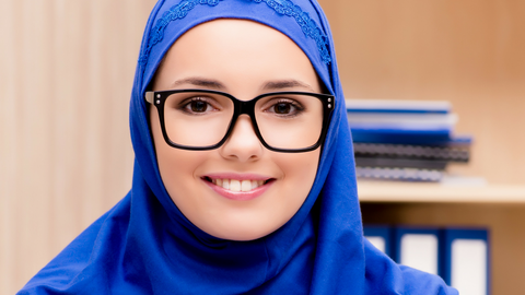 What should a female Muslim wear to work as a doctor or nurse?